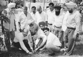 Mr A.J. Philip (sitting extreme left), Senior Associate Editor, The Tribune, plants a sapling on the banks of the Maharaja Ajj Sarovar in Kharar on Sunday.