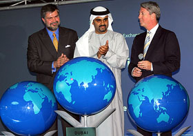 Emirati Omar Bin Suleiman, General Director of the Dubai International Financial Centre, applauds as he and Dubai International Financial Exchange Director Lynton Jones and DIFX Chairman Steffen Schubert officially open DIFX, the first international stock exchange located between Western Europe and East Asia, in Dubai on Monday