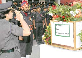 An officer pays tributes to the mortal remains of Capt M.M. Bokil at a ceremony organised at the Command Hospital in Chandimandir