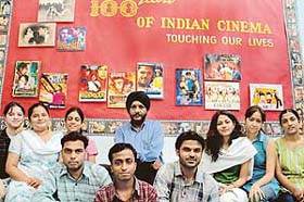 Applied Art students of Government Art College, Chandigarh, pose by the poster they have created on 100 Years of Indian Cinema