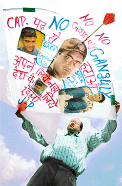 Kite-maker Jagmohan Kanojia holds a kite bearing photographs and slogans against Sourav Ganguly