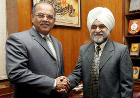 Pakistani Defence Secretary Tariq Waseem shakes hands with Indian Director-General of Civil Aviation Satendra Singh prior to their meeting in Rawalpindi on Tuesday