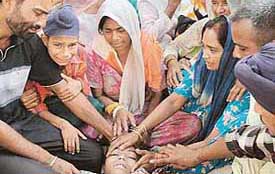 Inconsolable families of the two children who drowned in a pool at Bakarpur village, near Mohali, on Tuesday. 
