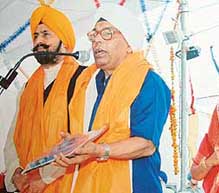 A file photo shows Bhanu Murthi, who has translated Gurbani into 17 languages, being honoured by Mr Avtar Singh Hit, a former DSGMC chief.
