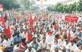 Trade unions hold a dharna outside the office of the Deputy Commissioner at the mini secretariat in Ludhiana on Thursday