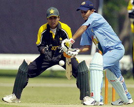 Indian under-21 womens team captain Karuna Jain plays a shot as Pakistan under-21 wicketkeeper Amran Khan looks on during the second one-day match at the Bagh-e-Jinnah stadium in Lahore on Thursday