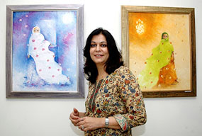 Kajal Nalwa with her paintings at Lalit Kala Akademi in New Delhi on Friday.