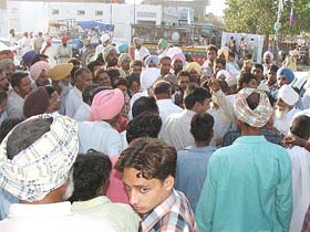 Angry farmers discuss the situation after they failed to get the MSP for their cotton produce on the inaugural day of procurement by government agencies in Bathinda