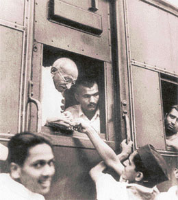 Gandhiji collects money for Harijan welfare while travelling by train.