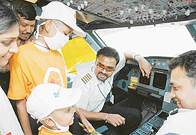 Cancer-afflicted children interact with the pilot inside the cockpit at the Chandigarh Airport on Sunday. 