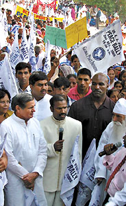 Delhi Health Minister Yoganand Shastri and former World Heavyweight Boxing champion Evander Holyfield during a peace march on the occasion of 136th birth anniversary of Mahatma Gandhi at Rajghat in the Capital on Sunday