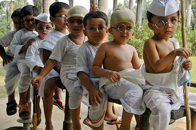 Children, dressed as Mahatma Gandhi, wait for their turn to perform during Mahatma Gandhi's 136th birth anniversary celebrations