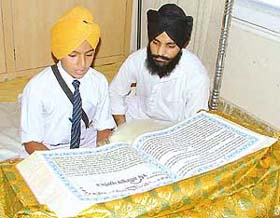 A student reads Guru Granth Sahib at a Sehaj Path competition organised by the GGSSC in Ludhiana