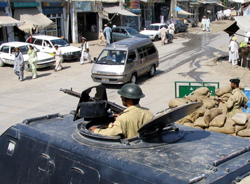 Pakistani paramilitary soldiers guard a street at a checkpoint in Miranshah