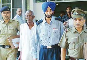 Banarsi Dass and Satpal Singh come out of the Sector 16 General Hospital after they sustained minor injuries when a gun went off accidentally in Sector 17