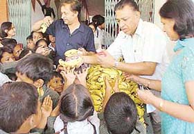 Mr Anil Jain and his wife distribute fruits among streetchildren after they adopted them to provide education in Panchkula