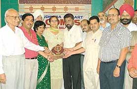 Ms Kanwal Walia receives the best teacher award from the Lions Club, Ludhiana Samrat, at a function in Ludhiana on Sunday. 
