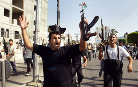 Palestinian policemen shouts after breaking into the Palestinian Parliament building