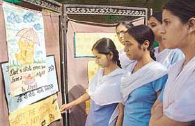 Students of Dev Samaj College of Education, Sector 36, Chandigarh, have a look at paintings at an exhibition on animal day held at their college