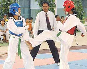 Sweety of Chandigarh region hits Neeti of Guwahati region during a taekwondo match during the 36th National Sports meet at KV-3BRD