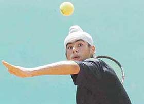 Mandeep Singh of St Johns School hits a shot during a semifinal match against Solin Chandan in the under-17 Inter-School Lawn Tennis Meet at St Peters School