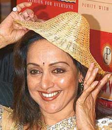 Veteran Bollywood actress and MP Hema Malini puts a gold straw hat during the launch of Shringar, a new range of exquisite jewellery, in New Delhi. 