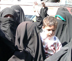 A member of the Dukhtaran-e-Milat holds her son during a protest in Srinagar against the arrest of the chief of the organisation Asiya Andrabi and her associates on Wednesday.