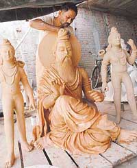  Idols of Valmiki flanked by those of Luv and Kush being prepared for a shobha yatra to be held on October 16. 