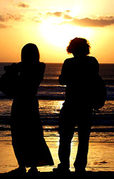 Tourists watch a sunset at Kuta beach, four days after bombs ripped through packed restaurants, in Bali on Wednesday