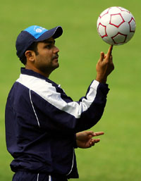 World XI player Virender Sehwag balances a soccer ball on his finger during a training session in Melbourne on Thursday