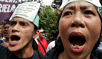 Protesters chant anti-government slogans during a rally demanding the resignation of Philippine President Gloria Macapagal Arroyo in Manila on Thursday