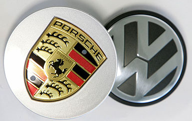 A file photo shows the logos of German carmakers Porsche and Volkswagen. Porsche, the German luxury sports car maker, said on Friday it has amassed a stake of more than 18 per cent in Volkswagen, making it the biggest single shareholder in Europes leading carmaker.
