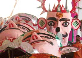 A woman artisan from Agra gives final touches to an effigy at the Daresi ground in Ludhiana