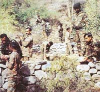 COMBATING EROSION: Jawans building check dams