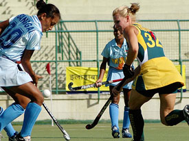 Indias Sanggai I. Chanu battles for the ball with an Australian player during the last league match of the seventh Indira Gandhi International Hockey Gold Cup in New Delhi on Friday