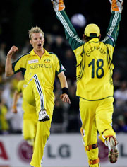 Australias Brett Lee rejoices with team-mate Adam Gilchrist after taking the wicket of World XI player Virender Sehwag