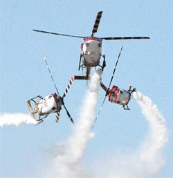 The Indian Air Force's Advanced Light Helicopters fly over New Delhi during the Air Force Day celebrations at Palam Airport on Saturday