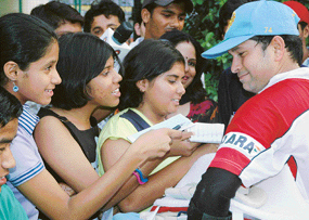 Sachin Tendulkar signs autographs for young fans at PCA Stadium, Mohali, on Sunday.