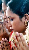 Bangladeshi women worship during the Durga Puja festival in Dhaka on Sunday