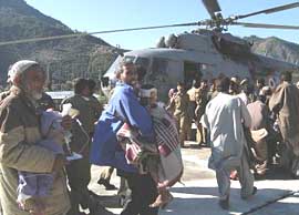 Relatives and jawans carry the injured to a helicoper for treatment in Srinagar from Tahgdhar, the area worst hit by Saturdays earthquake in Jammu and Kashmir, on Monday. 