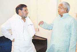 JD (U) leader Sharad Yadav and RJD chief Lalu Yadav in conversation at the Patna airport before leaving for Bihar election campaign on Monday.
