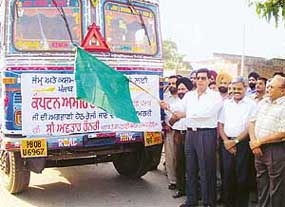 Punjab Food and Civil Supplies Minister Avtaar Henry flags off a convoy of trucks carrying relief material for quake-affected people of Jammu and Kashmir, in Jalandhar on Monday.