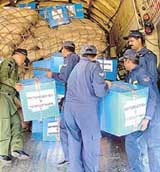 Air Force jawans load relief material for quake-hit people of Pakistan at Palam Air Force Station in New Delhi on Tuesday