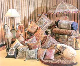 Richly textured ornate cushions add ethnic mood to the festival party decor