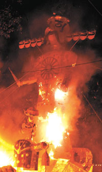 An effigy of Ravana bursts into flames at Subhash Ground in New Delhi on Wednesday, symbolising the victory of good over evil