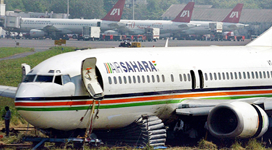Indian Airport Authority workers try to retrieve a Boeing 737, after it ran off the runway due to a faulty landing, in Mumbai on Wednesday. An Indian domestic flight overshot the runway on Sunday evening while landing as the pilot missed the touchdown by several metres