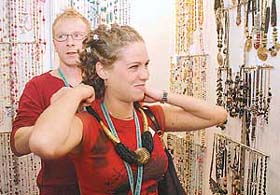 A foreigner tries jewellery at the Indian Handicraft and Gifts Fair in New Delhi