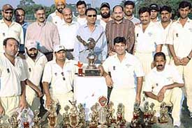 The Chandigarh Lawyers Sports Association cricket team with the winners trophy and other prizes