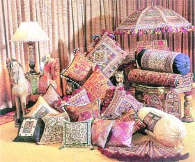 Richly textured ornate cushions add ethnic mood to the festival party decor