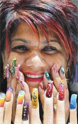 Beautician Pammy laughs as she holds her hands to her face